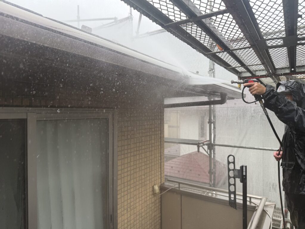 雨樋と軒天の隙間まで強力な高圧水流で洗浄する様子